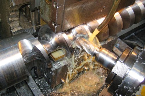 metalworking industry. cutting tool processing steel metal detail on turning lathe machine in workshop